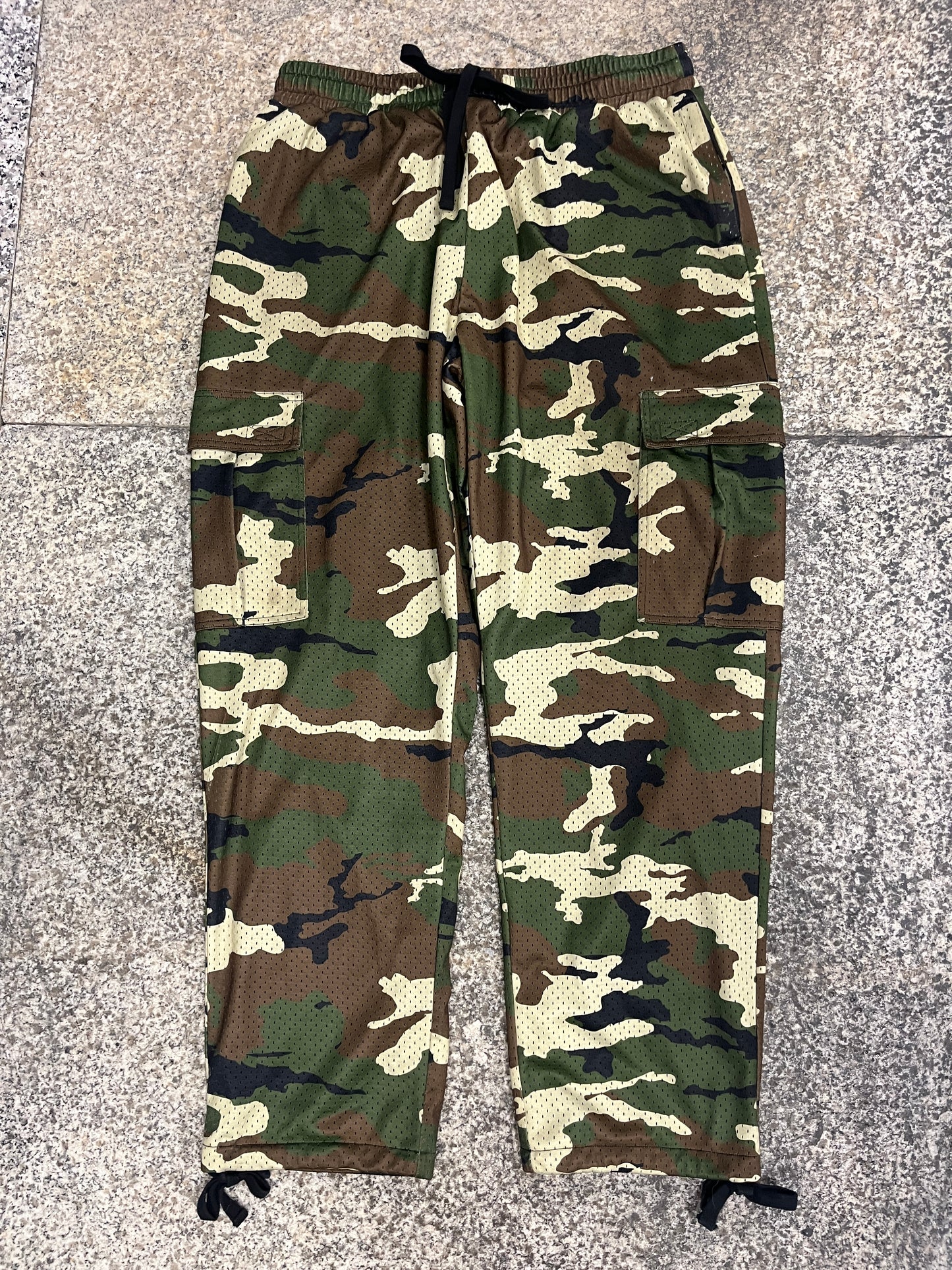 Camouflage-patterned pants on a gray floor